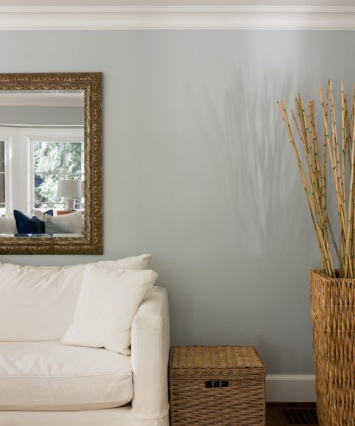 a nicely design room with a large mirror on the wall behind a white couch